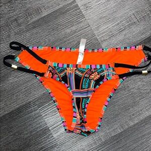 Gold rounds and colorful bikini lower